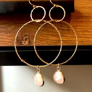 Gold hoop earrings with light pink gem
